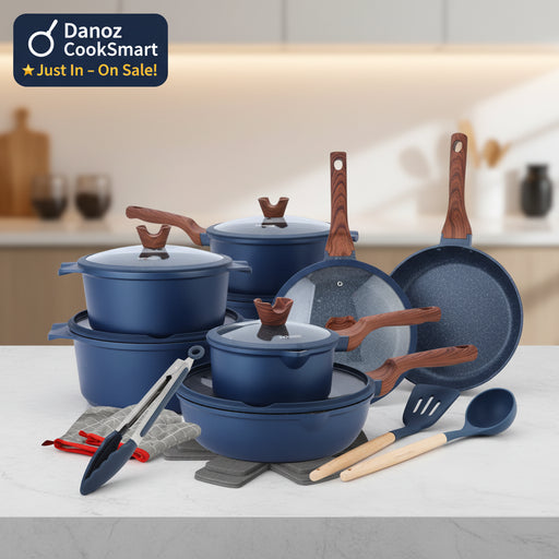 Kitchenware set with pots, pans, and utensils on a white background