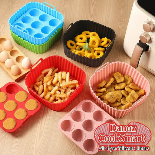 Silicone baking molds in various colors with food items on a wooden surface.