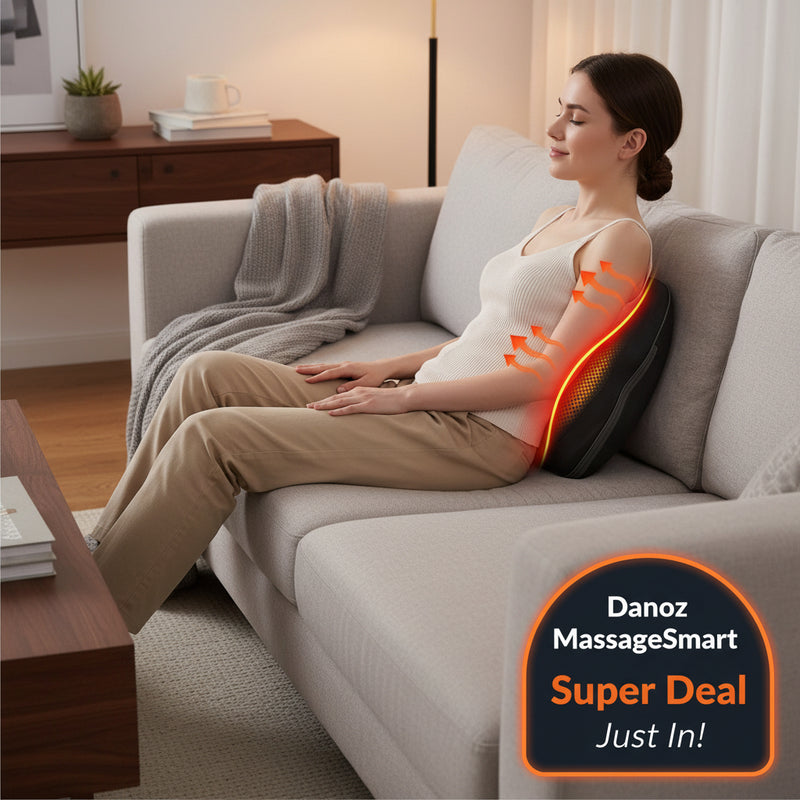 Black massage pillow being used on a person sitting on a couch with a focus on the back area.