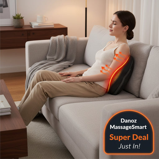 Black massage pillow being used on a person sitting on a couch with a focus on the back area.