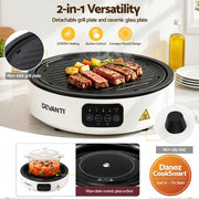 White Devanti 2-in-1 electric grill and ceramic cooker shown on a kitchen counter with food cooking on the grill plate, plus callout insets and feature text explaining detachable grill plate, button control, compact round design, non-stick plate, non-slip feet, and ceramic glass surface.
