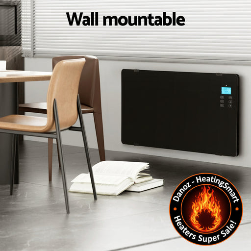 Wall-mounted electric heater in a room with chairs and a table, featuring a remote control.