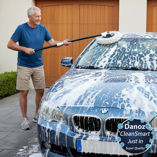 Car cleaning tool with a scrubber pad being used on a car windshield.