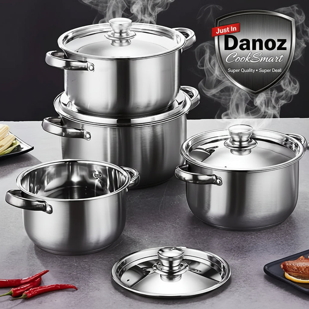 Set of stainless steel cookware on a gray surface with a dark background