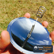 Metallic fishing bobber with coiled wire held by a hand against a grassy background