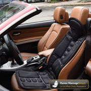 Car interior with a black massage seat pad on brown leather seats.