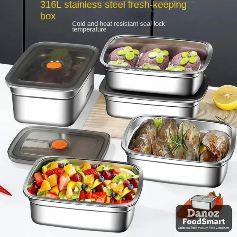 Set of stainless steel food containers with food inside on a white surface.