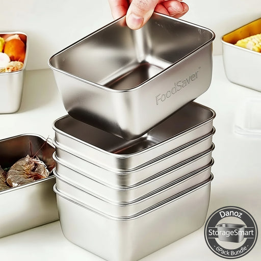 Stack of metal food containers with a hand lifting one, on a kitchen counter.