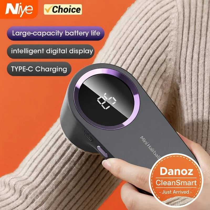 Hand holding a gray and purple hairball trimmer with Niyé and Choice branding on an orange background.