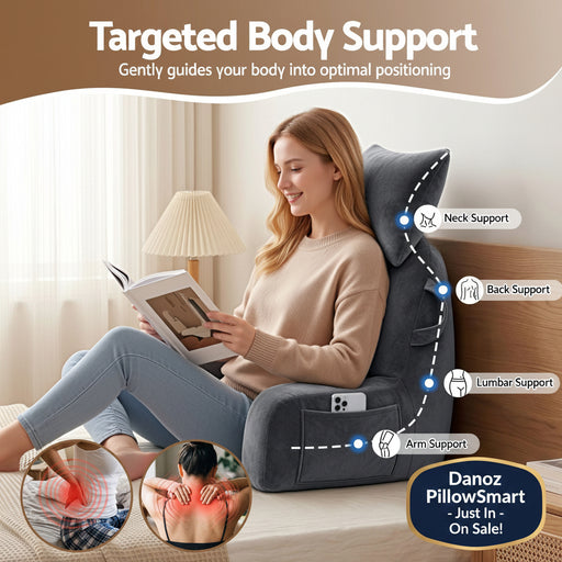 A woman sits in a dark gray body support recliner chair in a bedroom setting, reading a book. The image includes text callouts for Neck Support, Back Support, Lumbar Support, and Arm Support, along with two circular inset images showing back pain relief.