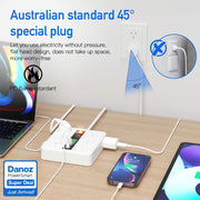 White power strip with multiple outlets on a wooden desk, featuring Australian standard 45-degree plug design.