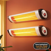 Two wall-mounted infrared heater strips glowing with orange light on a terracotta-colored wall, with a window frame and plant leaves visible at the edges.