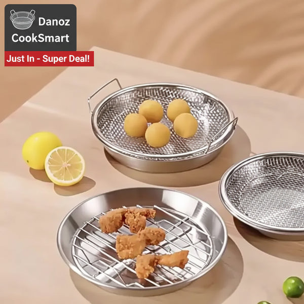 Metallic grilling baskets with food on a beige surface
