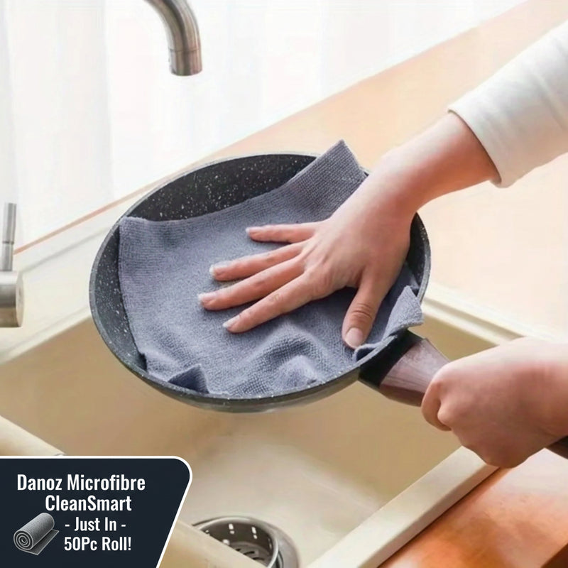 Person cleaning a frying pan with a blue cloth over a sink.