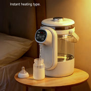 Electric bottle warmer on a wooden surface with a jar of milk and a baby bottle.
