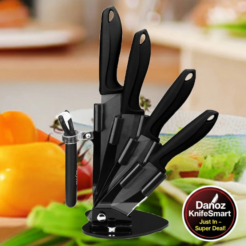 A black kitchen knife block set with four knives and a peeler, shown in a kitchen setting with vegetables in the blurred background. The brand name 'Akatsuki' is visible in the top left corner.