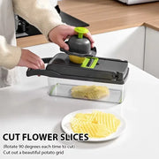 Person using a vegetable slicer to cut potatoes on a kitchen counter.