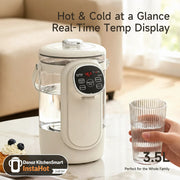 White electric jug with digital display on a marble surface, next to a glass of water and a dessert.