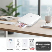 White portable photo printer with accessories on a white background