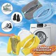 Washing machine with cleaning rags and shoes against a blue sky background