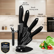 Black 5-piece kitchen knife set with a matching stand, including a 6-inch chef knife, 5-inch slicing knife, 4-inch utility knife, 3-inch paring knife, and a peeler, shown on a white background with a small vegetable garnish and text labels.