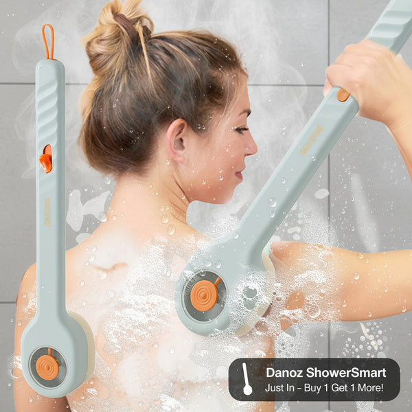 Woman using a handheld shower scrubber with soap suds on a white background