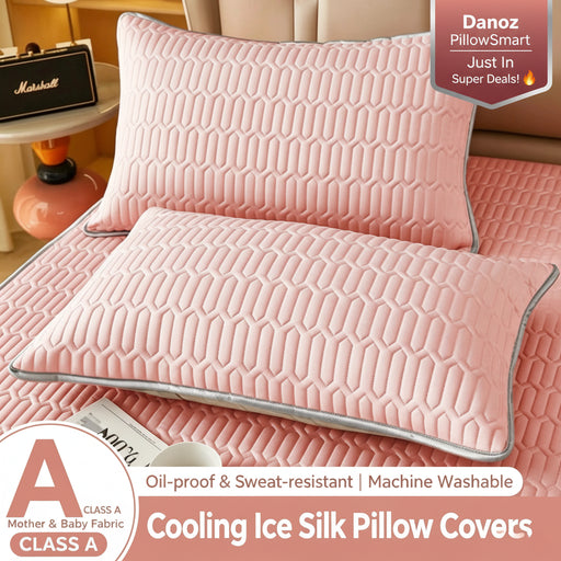 Two pink quilted pillow covers with a geometric pattern and gray piping, displayed on a bed alongside a matching pink sheet. A circular badge at the bottom left shows an 'A' rating, and text overlays describe the product as 'Cooling Ice Silk Pillow Covers'.