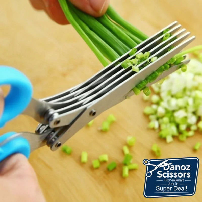 Scissors cutting green onions on a wooden surface