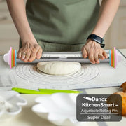 Person using a colorful rolling pin on dough with a kitchen setting in the background