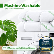 White plush bath towels stacked on top of a white washing machine, with green text reading 'Machine Washable' and 'Easy to use and maintain,' plus a plant leaf on the left.