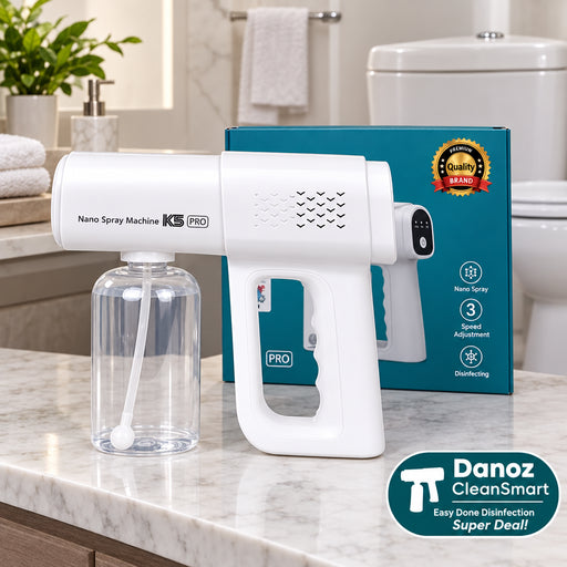 White nano spray machine with clear container against a blue sky background