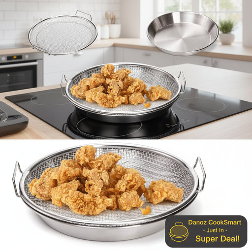 Stainless steel deep frying basket with fried chicken on a white background