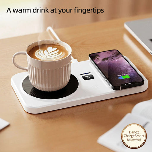 Hot drink cup on a desk with a smartphone on a white charging pad, text 'A warm drink at your fingertips Keeps you cozy all winter long'.