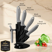 Four-piece kitchen knife set with gray handles and a black stand, shown on a white background with text labels identifying each knife size and a peeler, plus a small vegetable garnish in the corner.