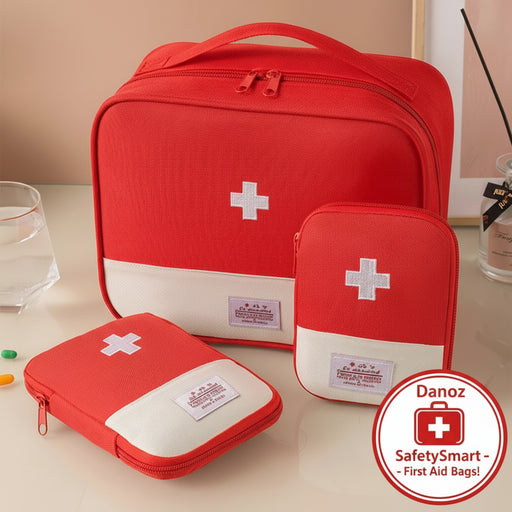 Set of red first aid kits with white crosses on a beige surface