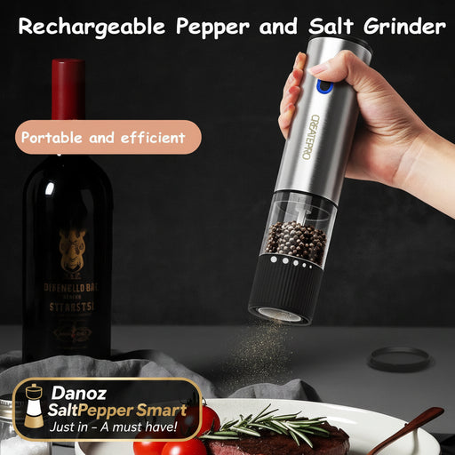 Rechargeable pepper and salt grinder being used over a dish with tomatoes and herbs, with a bottle in the background.