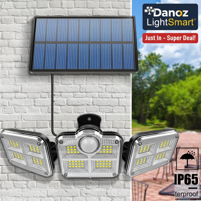 Solar-powered outdoor light system with motion sensor on a brick wall.