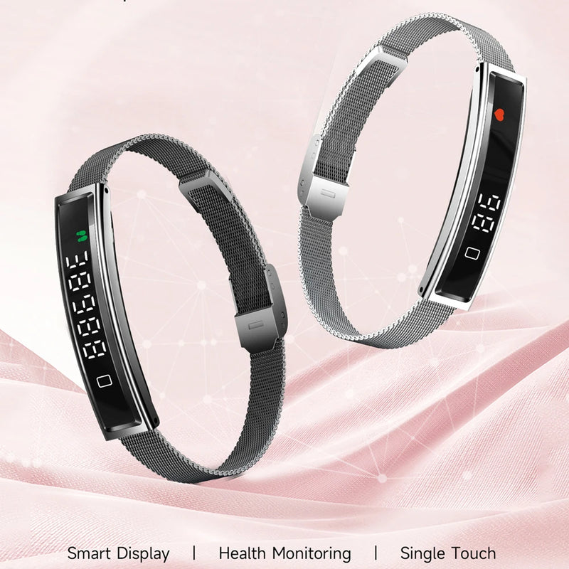 Two smart bracelets with digital displays on a pink fabric background