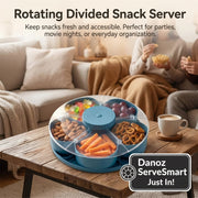 Rotating divided snack server on a wooden table with snacks and people in the background.