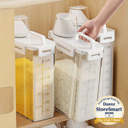 Three white kitchen storage containers with measurement markings on a wooden shelf.