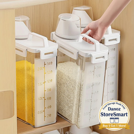 Three white kitchen storage containers with measurement markings on a wooden shelf.