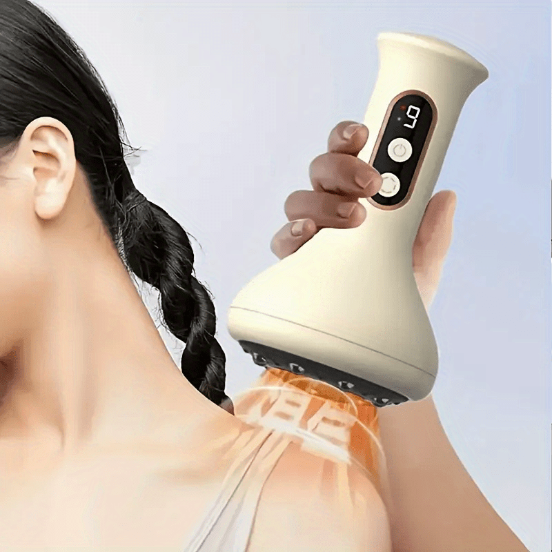 Person using a handheld massager on their shoulder against a light background