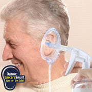 Person using an ear cleaning device on a beige background