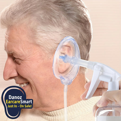 Person using an ear cleaning device on a beige background