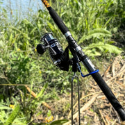 Fishing rod with reel against a natural background