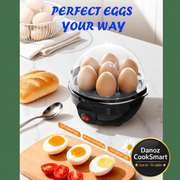 Egg cooker with eggs on a table with bread and tomatoes