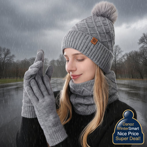 Person wearing a gray knit hat with a pom-pom, scarf, and gloves on a white background