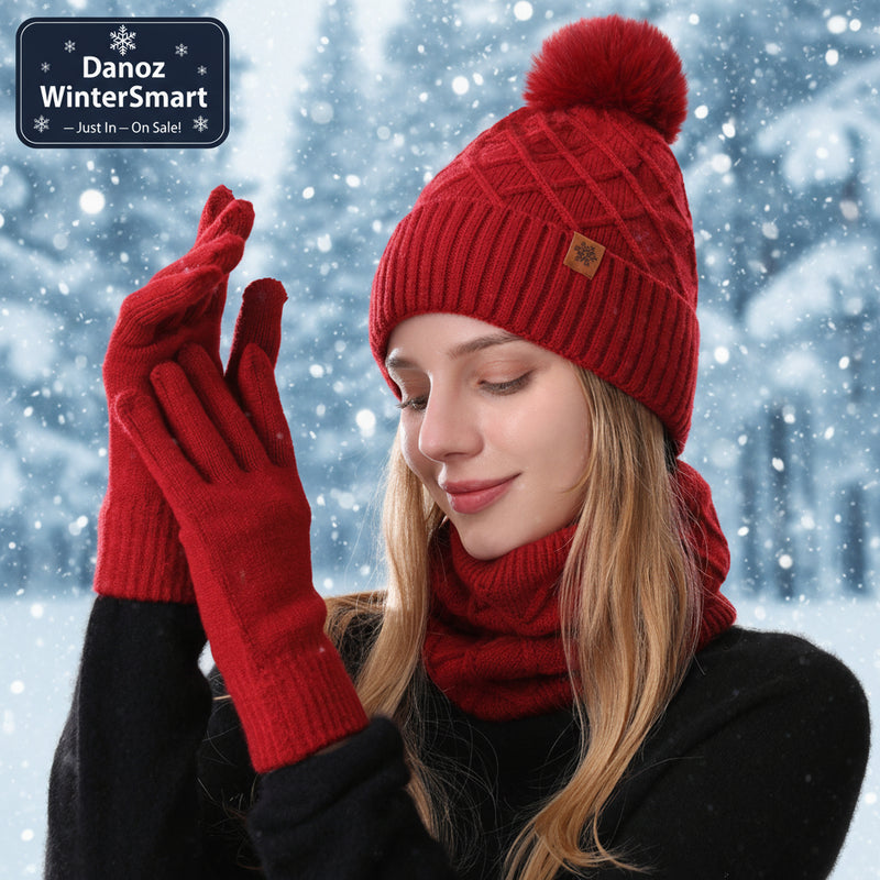 Woman wearing a red knit hat, scarf, and gloves on a white background