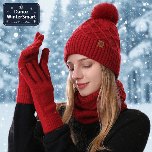 Woman wearing a red knit hat, scarf, and gloves on a white background