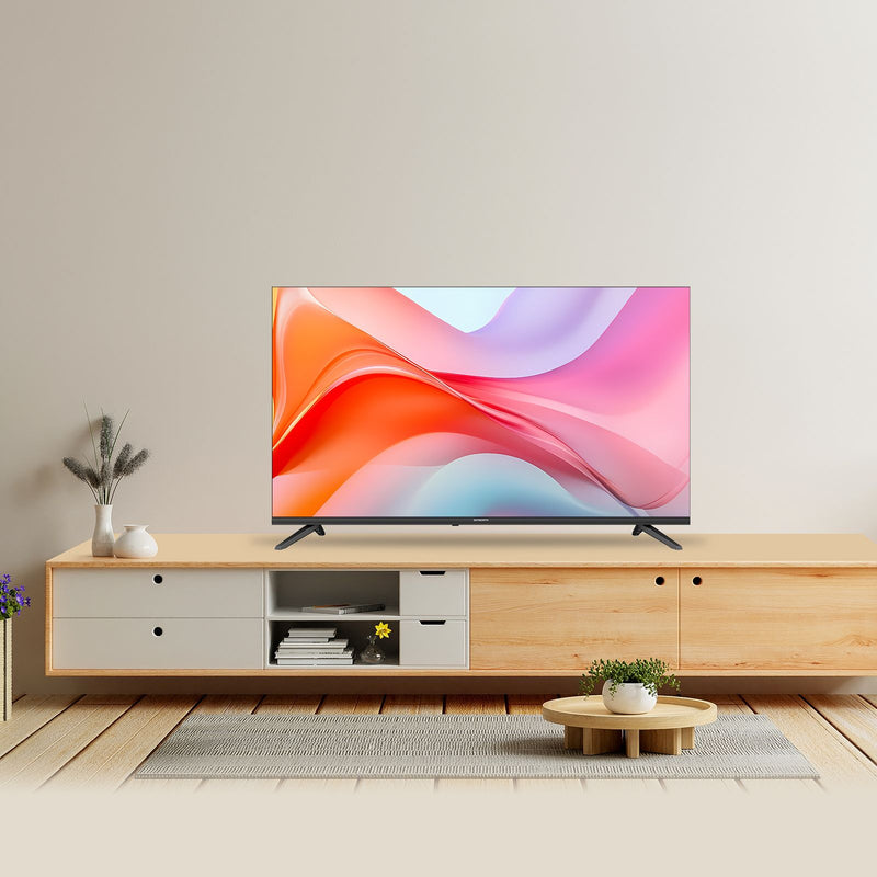 A modern flat-screen TV with a colorful abstract display sits on a light wood and white media console in a minimalist living room setting.
